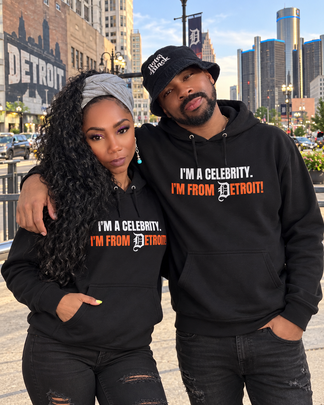 Retro Black couple wearing I'm a Celebrity. I'm from Detroit! black hoodies in downtown Detroit