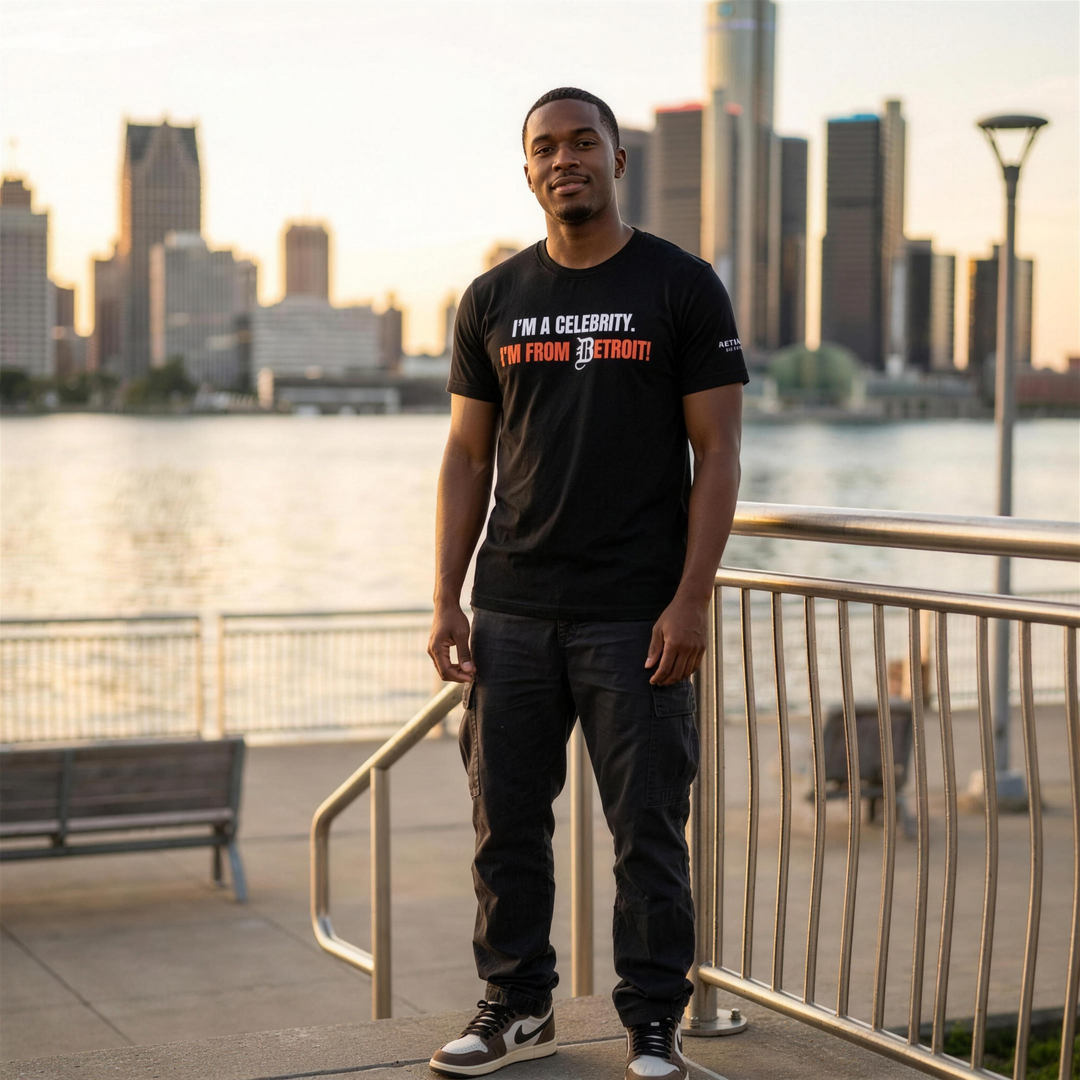 Black man wearing the Retro Black I'm From Detroit tee at the Detroit riverfront
